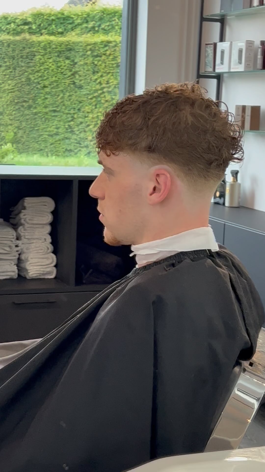 Curly textured top with a soft fade